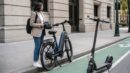 A generic e-bike and electric scooter beside a city bike lane