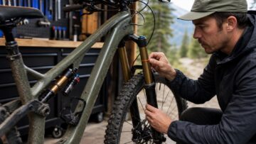 Mountain bike suspension sag being checked at a fork and rear shock.