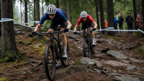Two mountain bikers racing through a technical forest trail