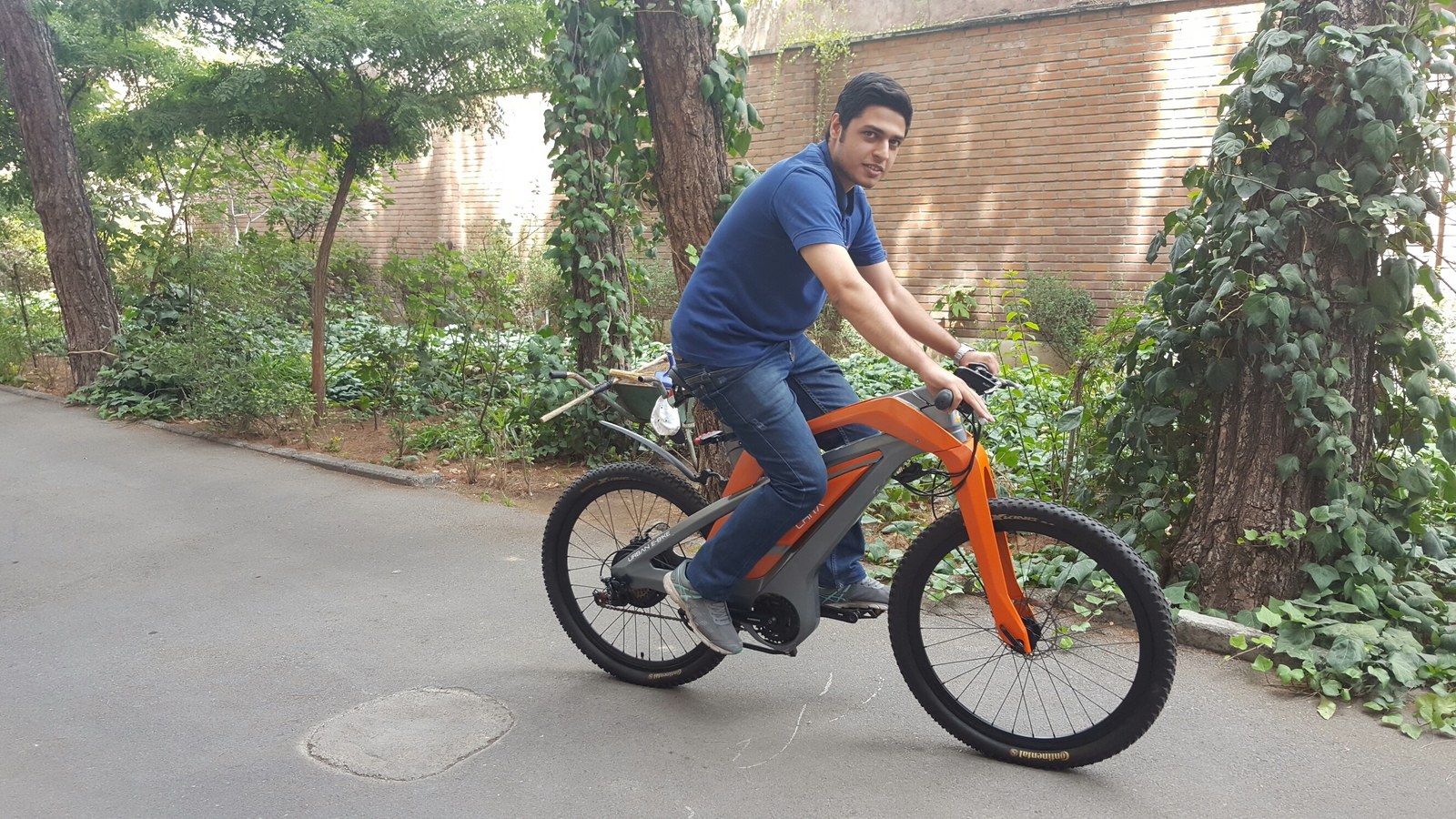 A rider on an electric bicycle on a paved path.