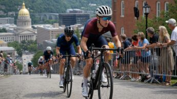 Under-23 road cyclists climbing an urban race course during summer national championship coverage.